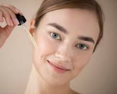 Aesthetic professional performing microneedling with exosome serum application in a sterile 2026 clinical environment.